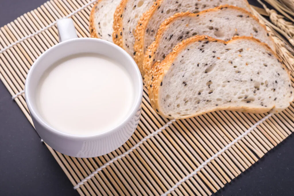 slices fresh white bread with sesame seeds black stone
