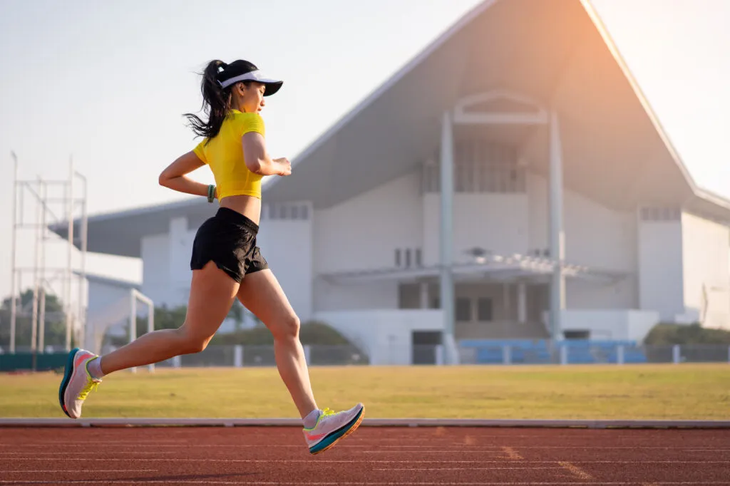 young asian woman athlete runner jogging running track city stadium sunny morning keep fitness healthy lifestyle young fitness woman runs stadium track sport recreation 1