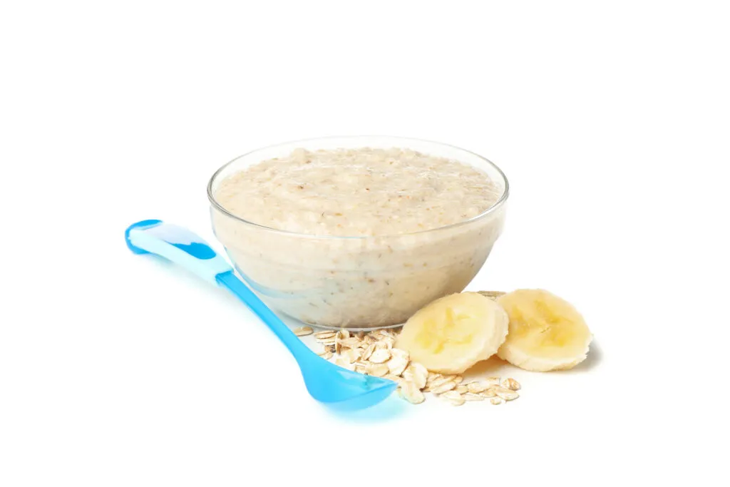 bowl with healthy baby food isolated white background