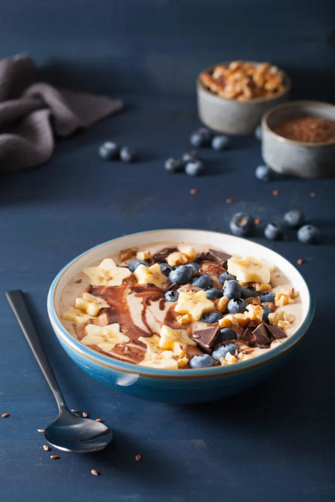 healthy banana smoothie bowl with blueberry chocolate walnuts